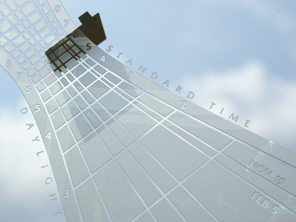 Spectra sundial closeup view showing time shadow, etched hour lines, and personalized anniversary and birthday date lines.